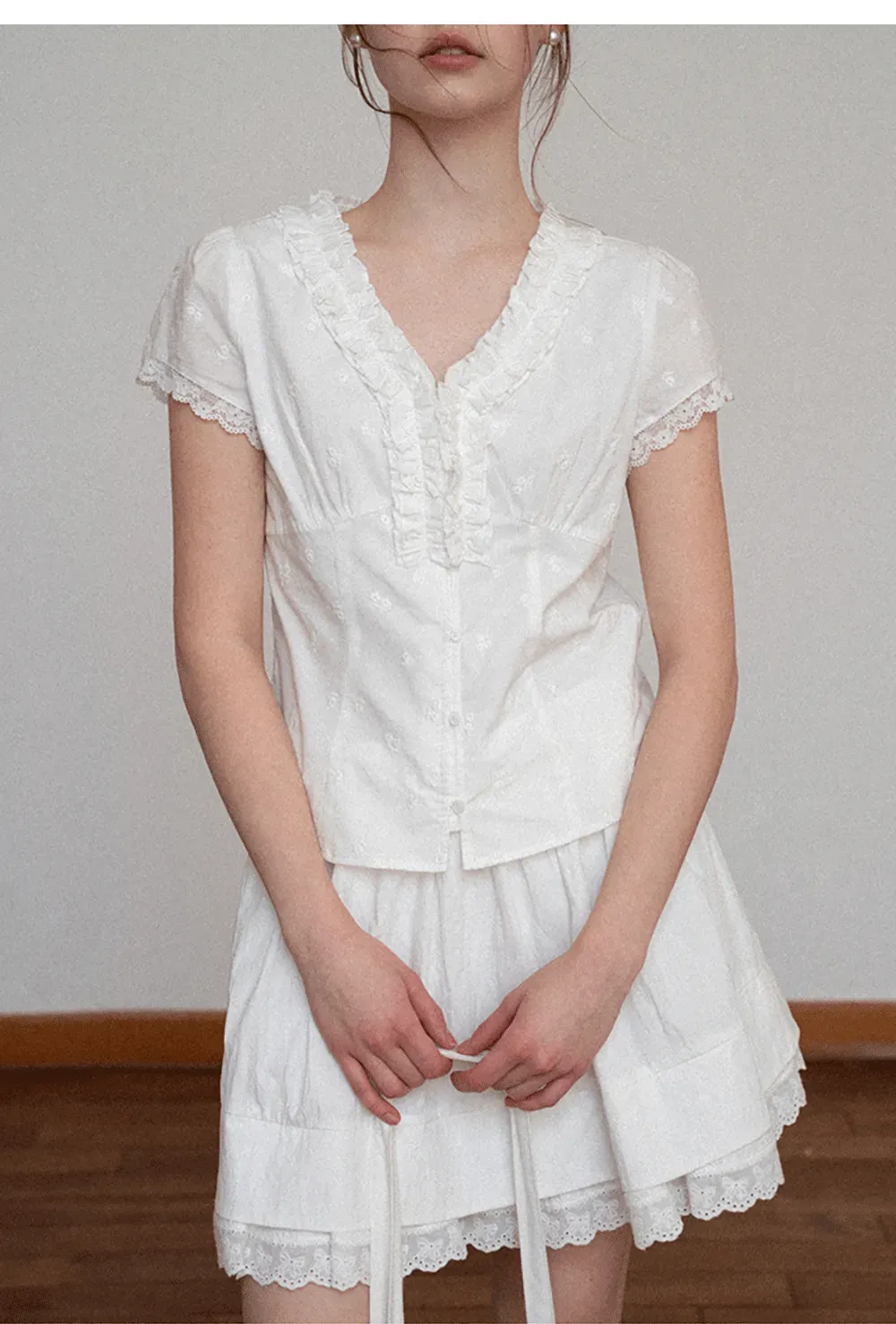 Embroidered short sleeve top with ruffled V neck and lace trim