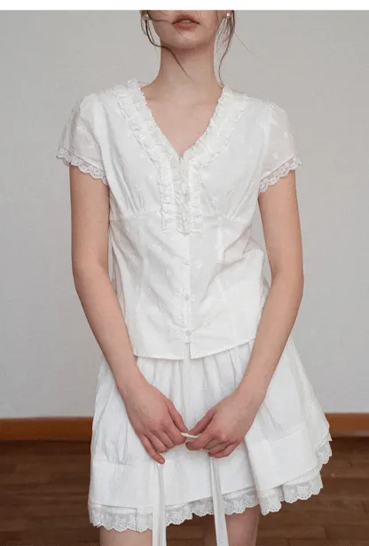 Embroidered short sleeve top with ruffled V neck and lace trim