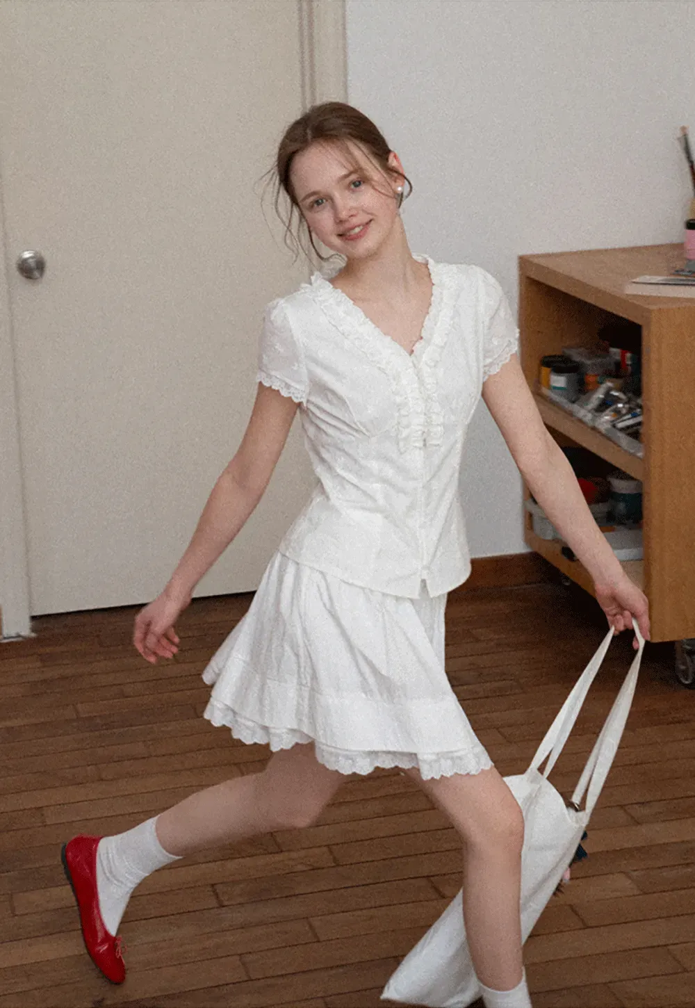 Embroidered short sleeve top with ruffled V neck and lace trim