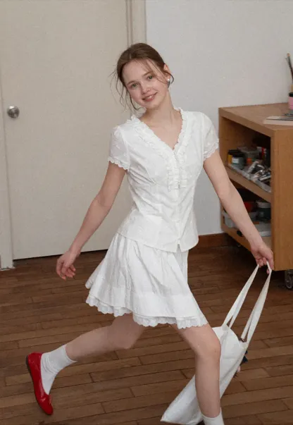 Embroidered short sleeve top with ruffled V neck and lace trim