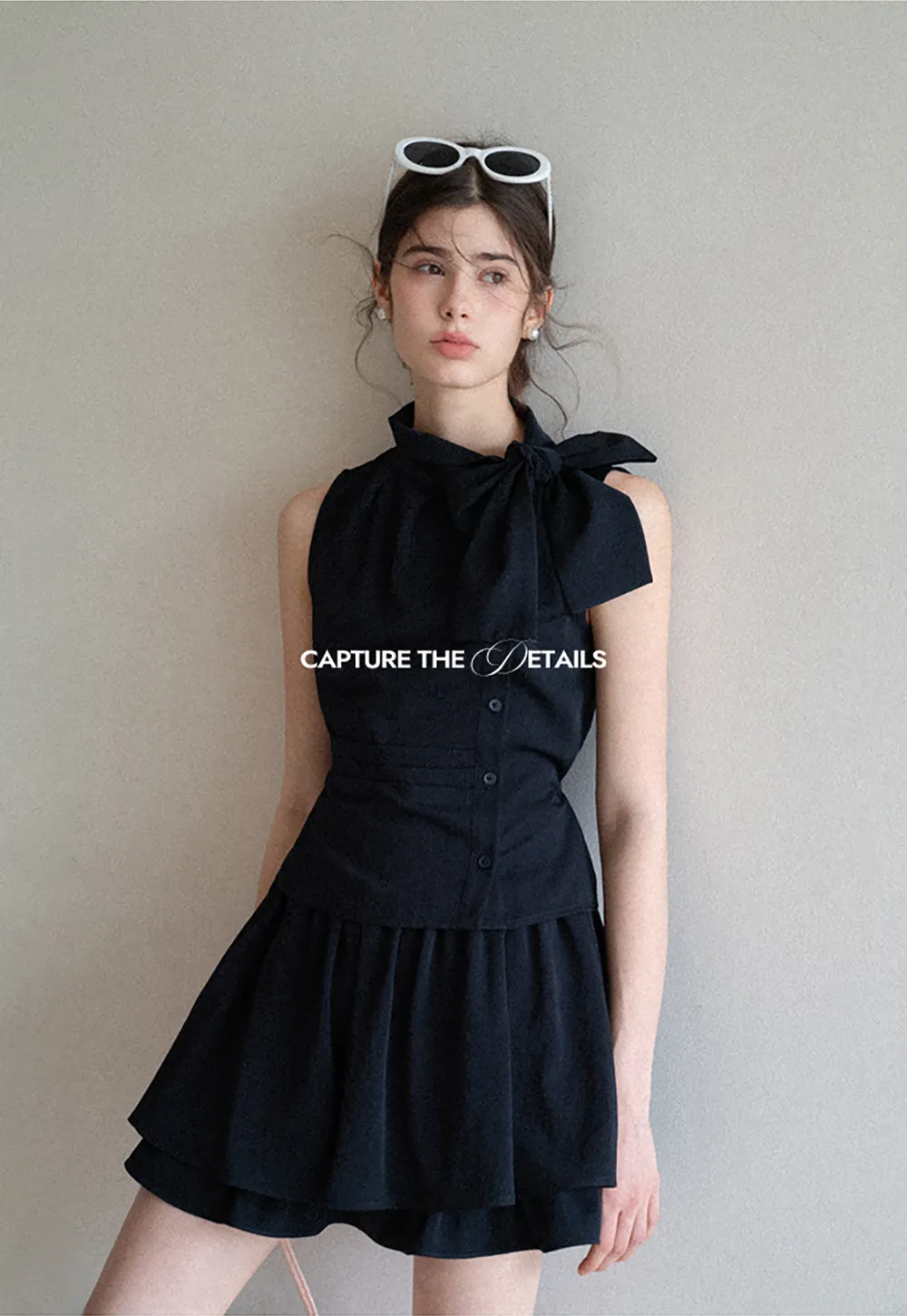 Sleeveless top with bow detail and pleated skirt