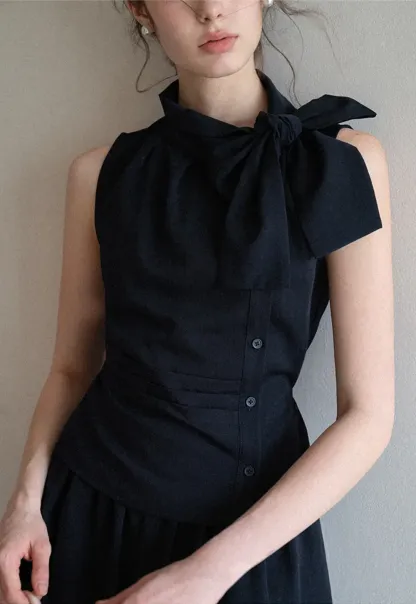 Sleeveless top with bow detail and pleated skirt