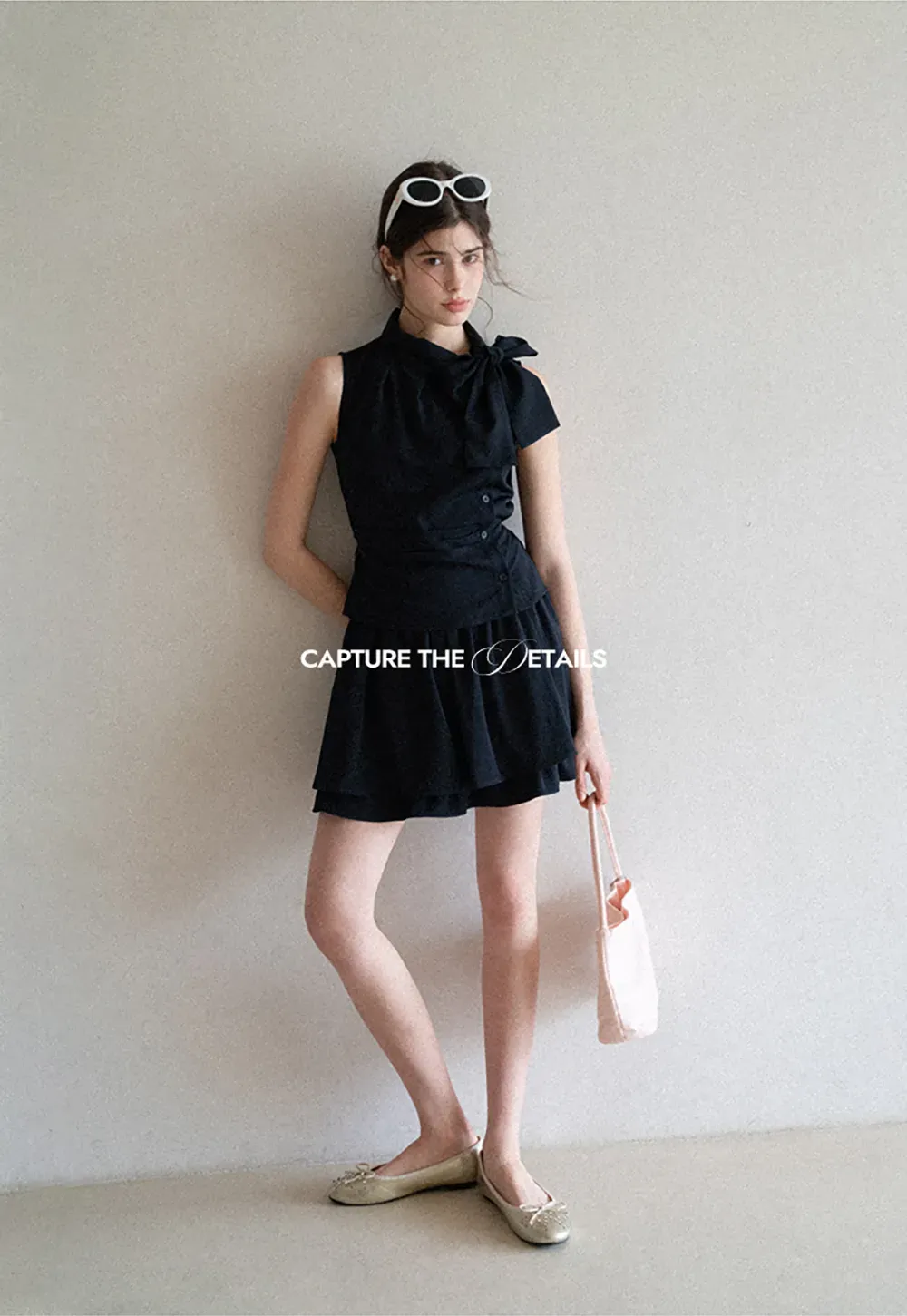 Sleeveless top with bow detail and pleated skirt