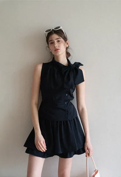 Sleeveless top with bow detail and pleated skirt
