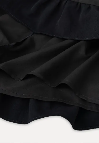 Sleeveless top with bow detail and pleated skirt