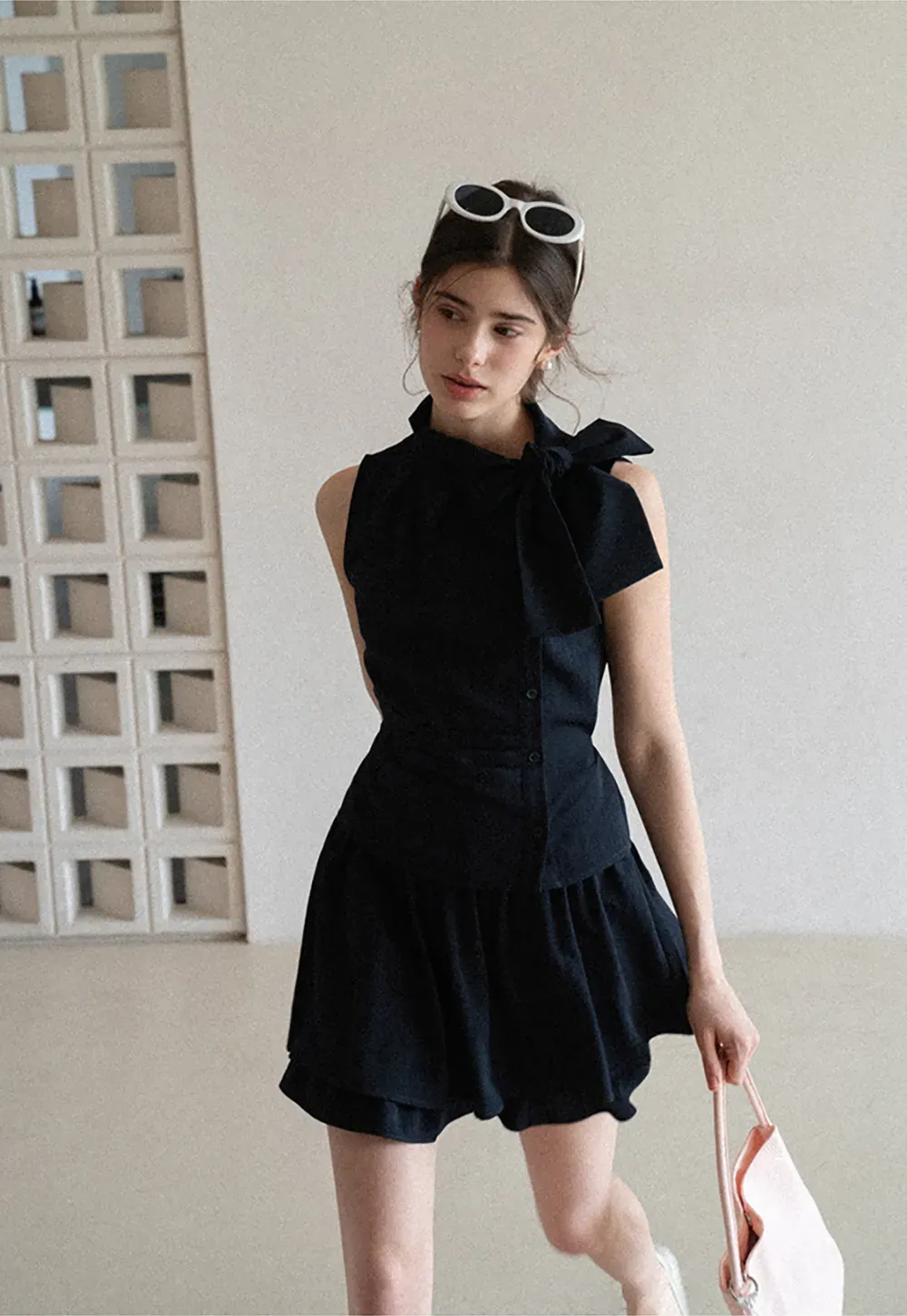 Sleeveless top with bow detail and pleated skirt