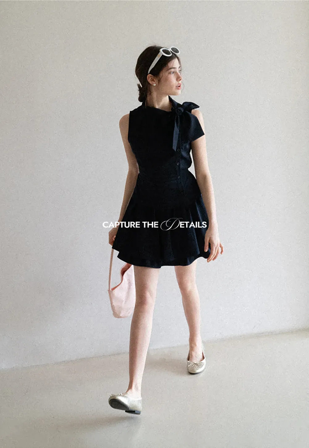 Sleeveless top with bow detail and pleated skirt