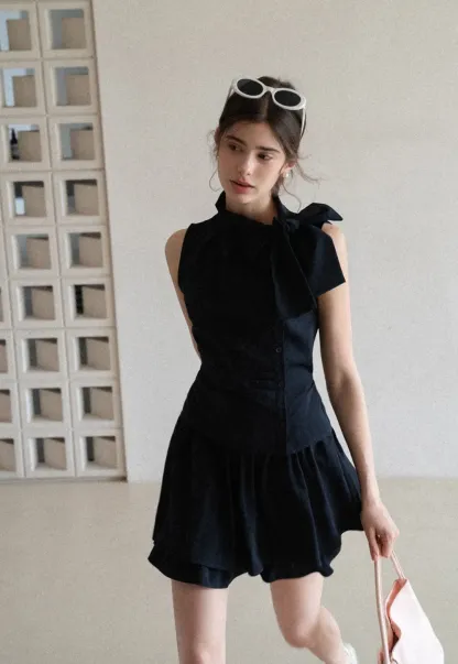 Sleeveless top with bow detail and pleated skirt