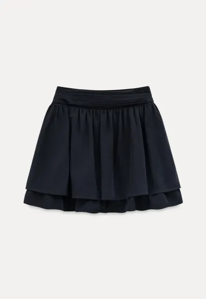 Sleeveless top with bow detail and pleated skirt
