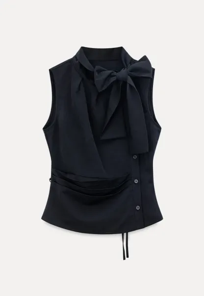 Sleeveless top with bow detail and pleated skirt