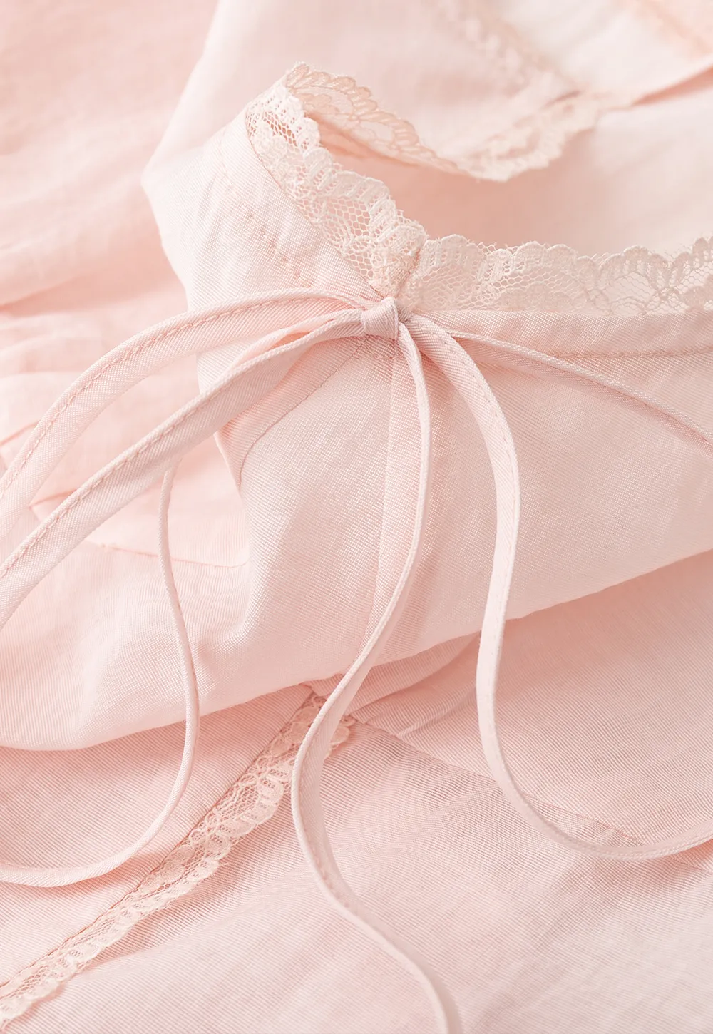 Sheer lace trim camisole with front tie and peplum hem