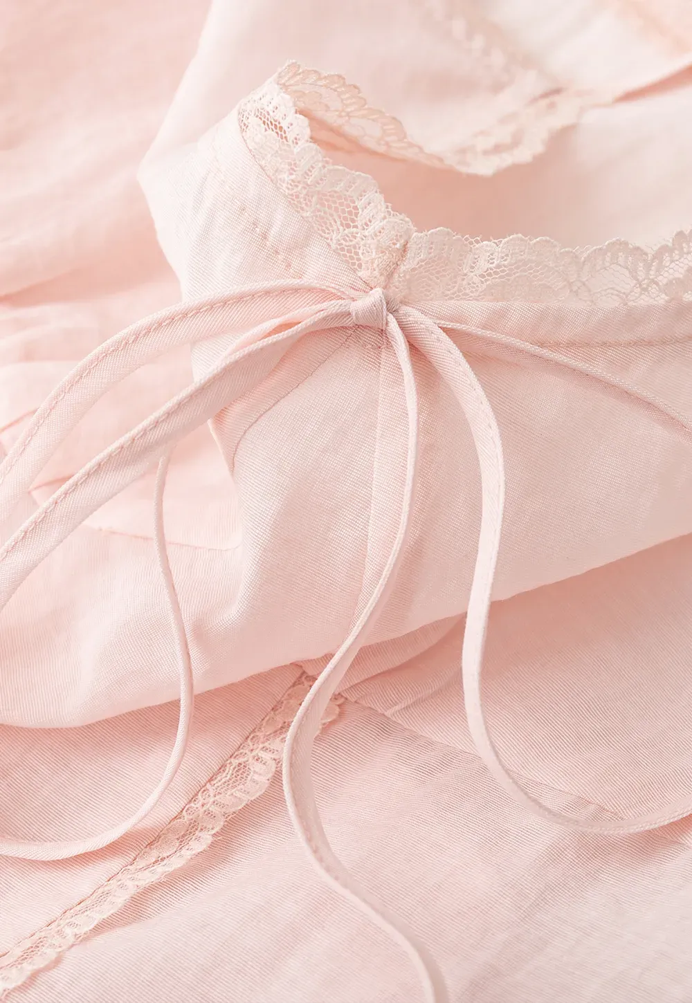 Sheer lace trim camisole with front tie and peplum hem