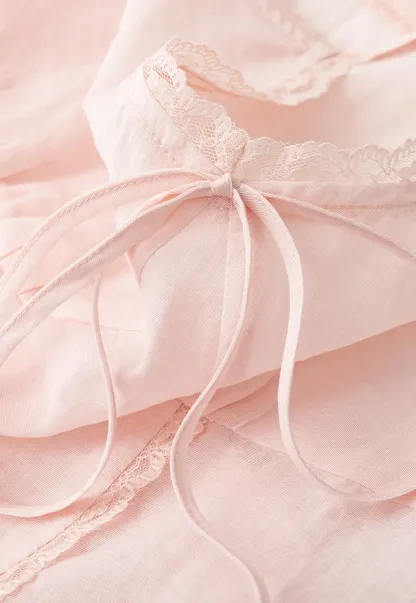 Sheer lace trim camisole with front tie and peplum hem