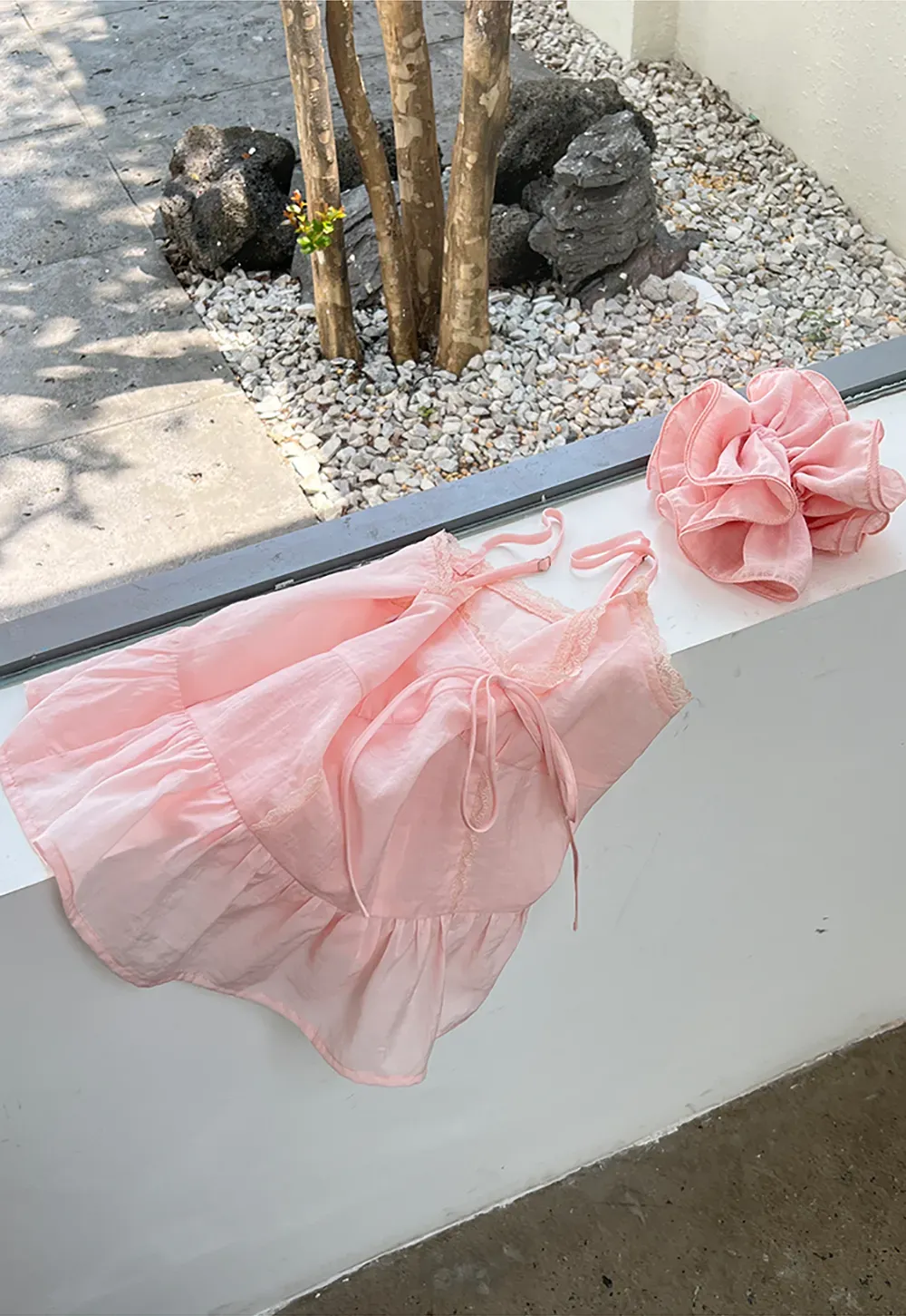 Sheer lace trim camisole with front tie and peplum hem