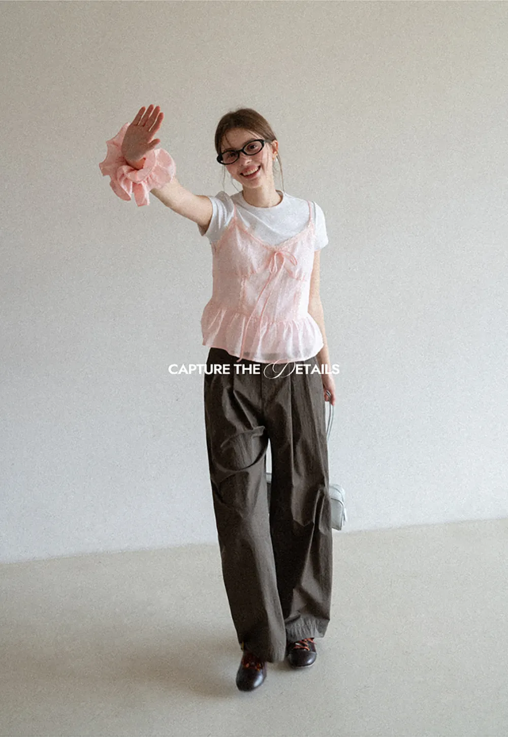 Sheer lace trim camisole with front tie and peplum hem