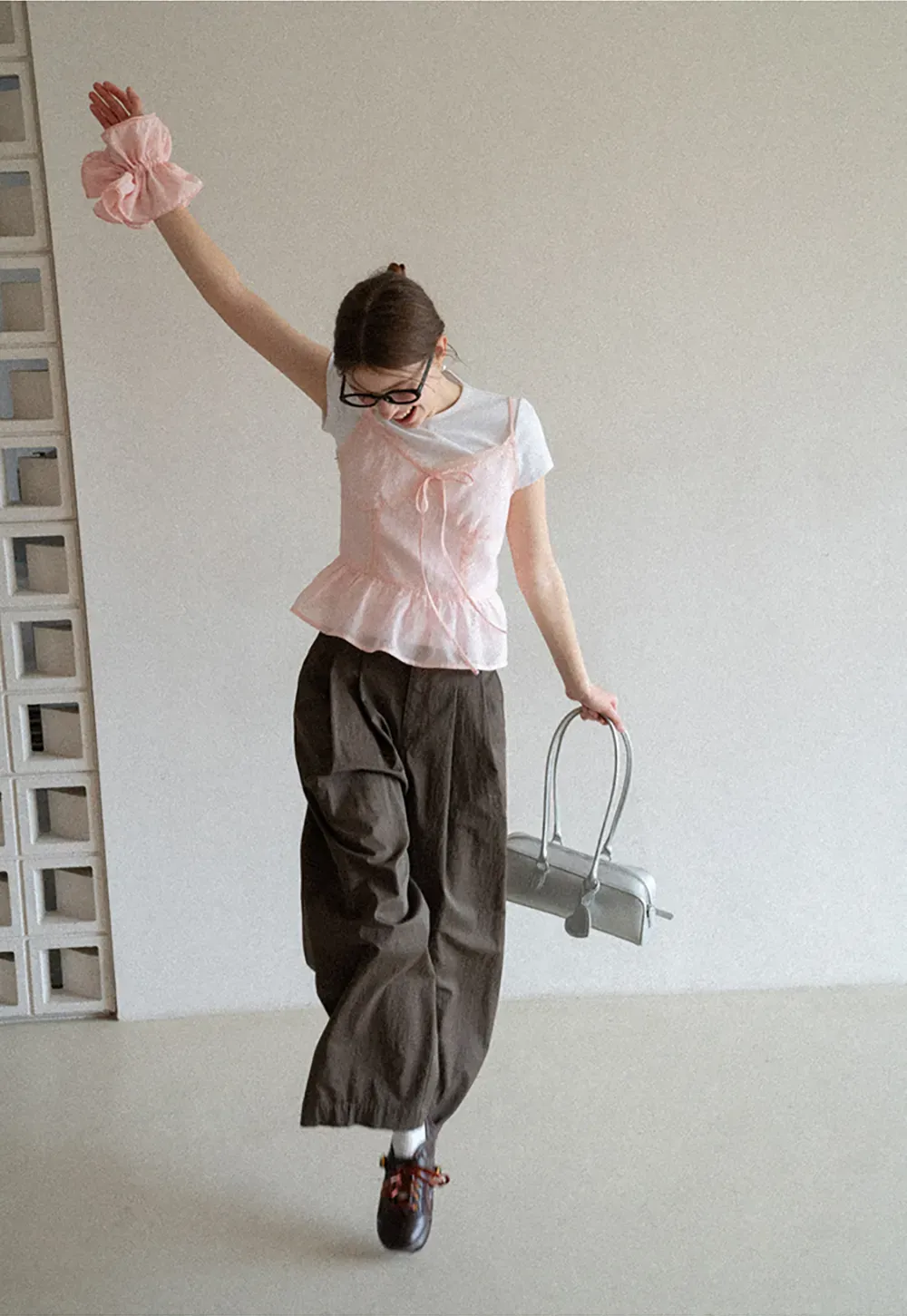 Sheer lace trim camisole with front tie and peplum hem