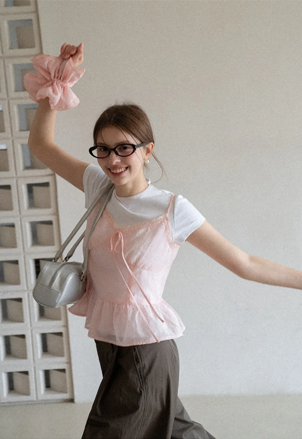 Sheer lace trim camisole with front tie and peplum hem