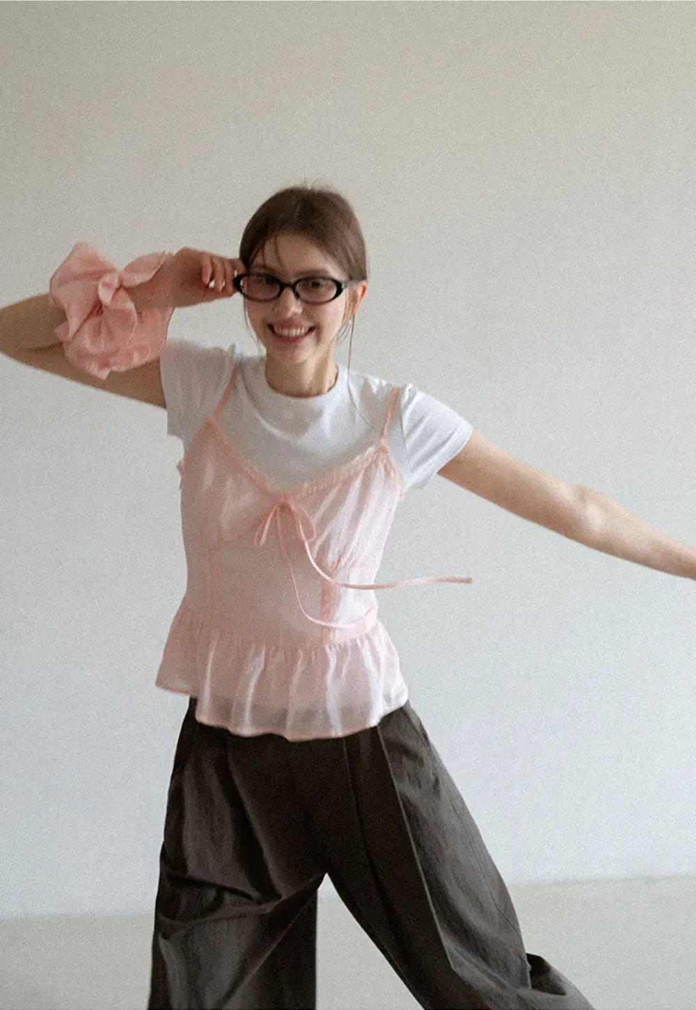 Sheer lace trim camisole with front tie and peplum hem