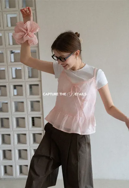 Sheer lace trim camisole with front tie and peplum hem