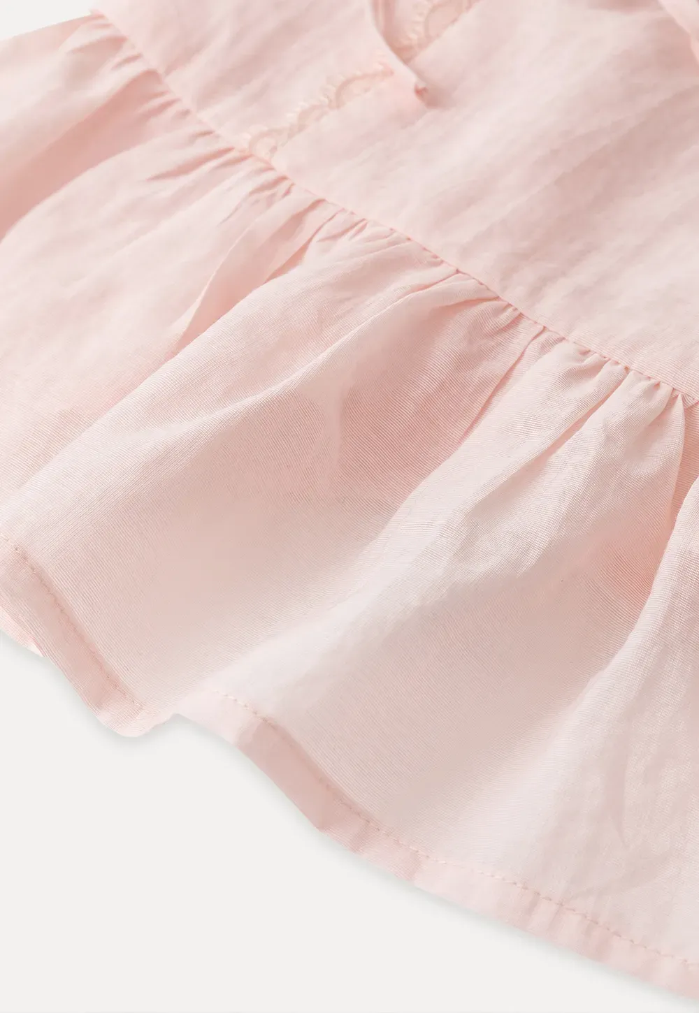 Sheer lace trim camisole with front tie and peplum hem