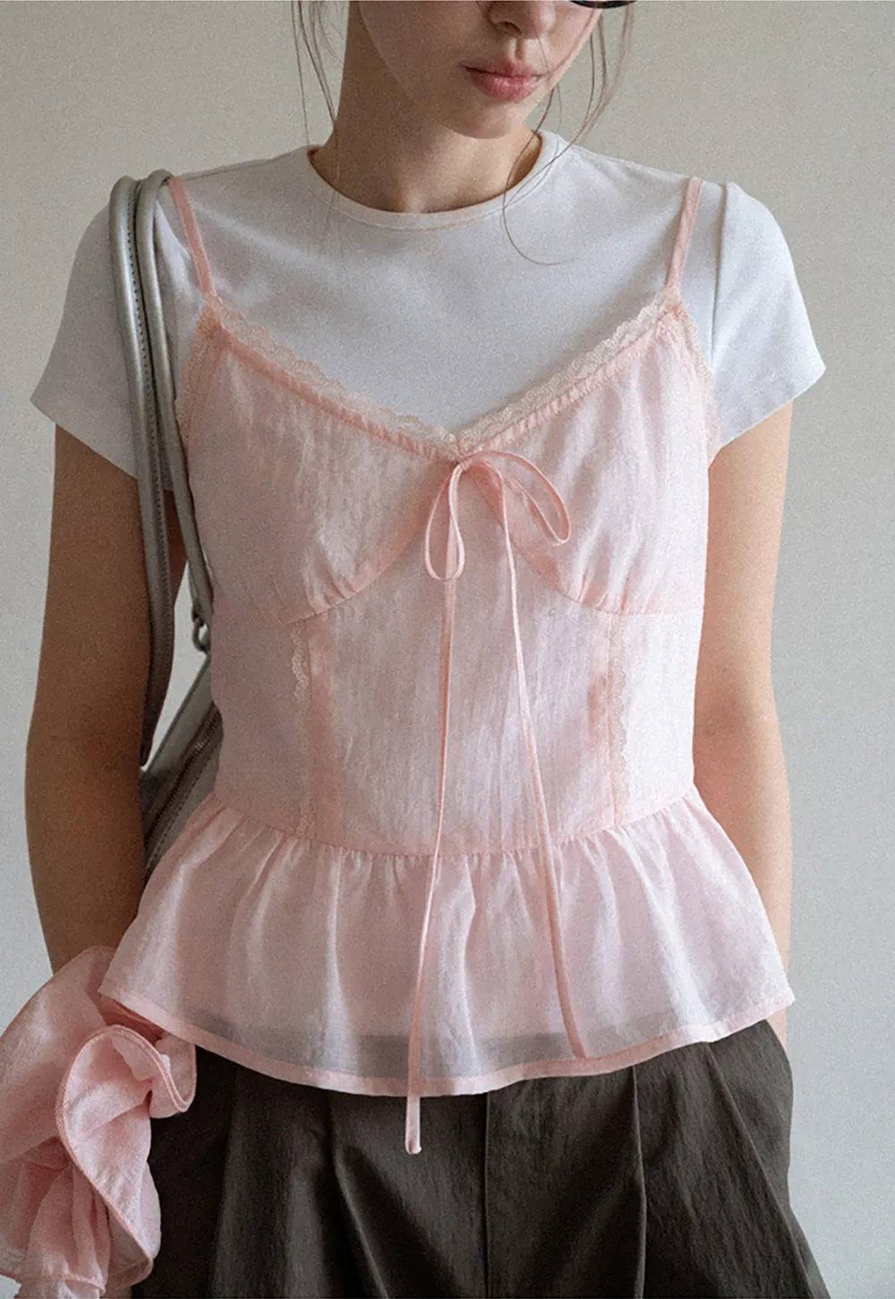 Sheer lace trim camisole with front tie and peplum hem