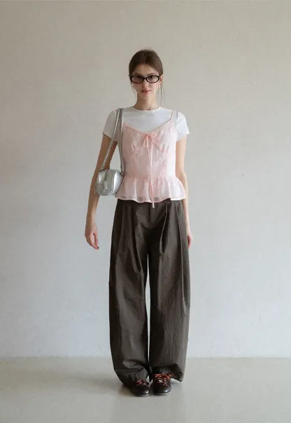 Sheer lace trim camisole with front tie and peplum hem