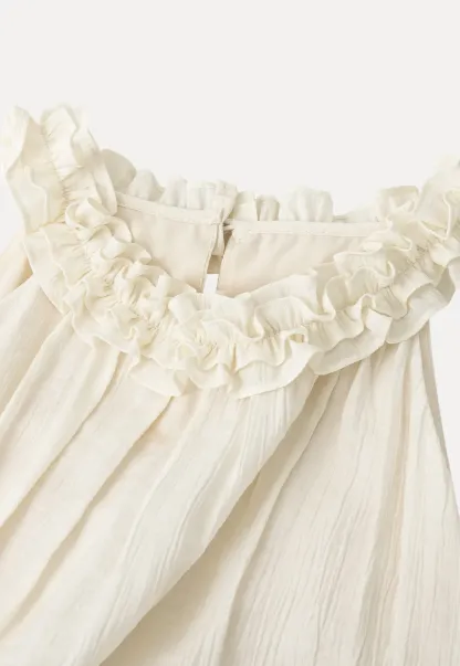 Sleeveless blouse with ruffled neckline and pleats