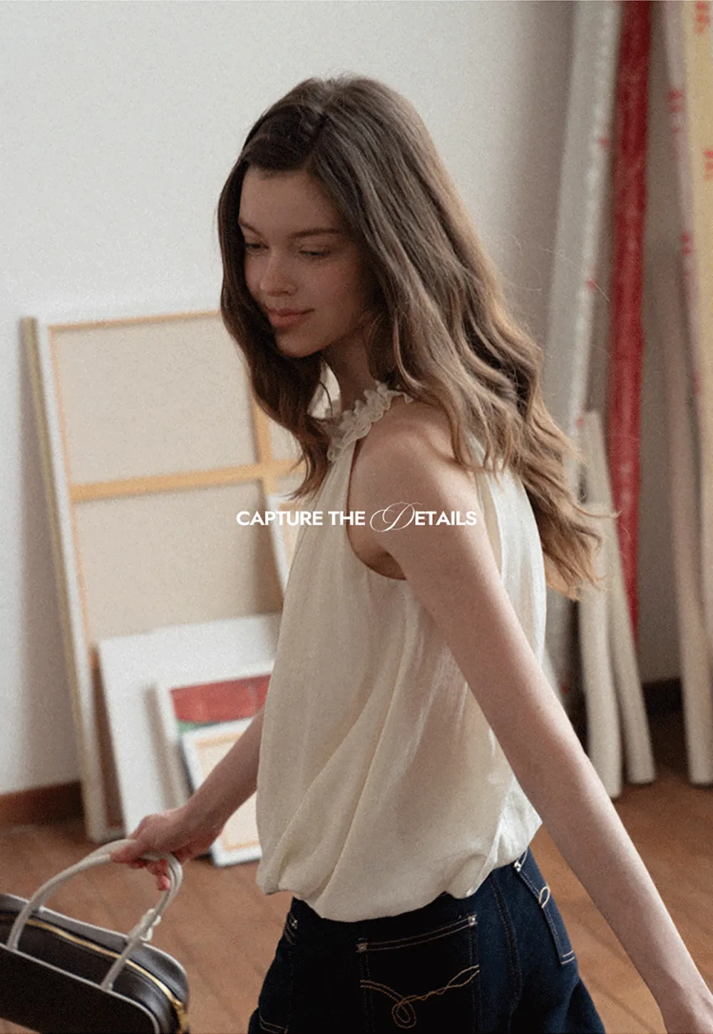 Sleeveless blouse with ruffled neckline and pleats