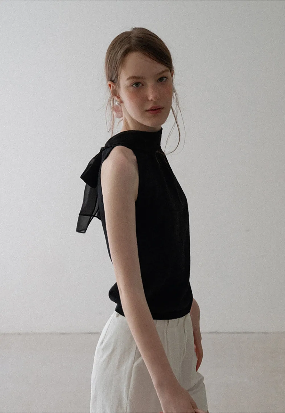Pull sans manches en maille avec nœud papillon dans le dos