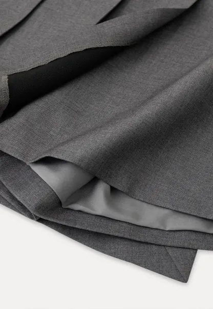 Pleated skirt with front button closure