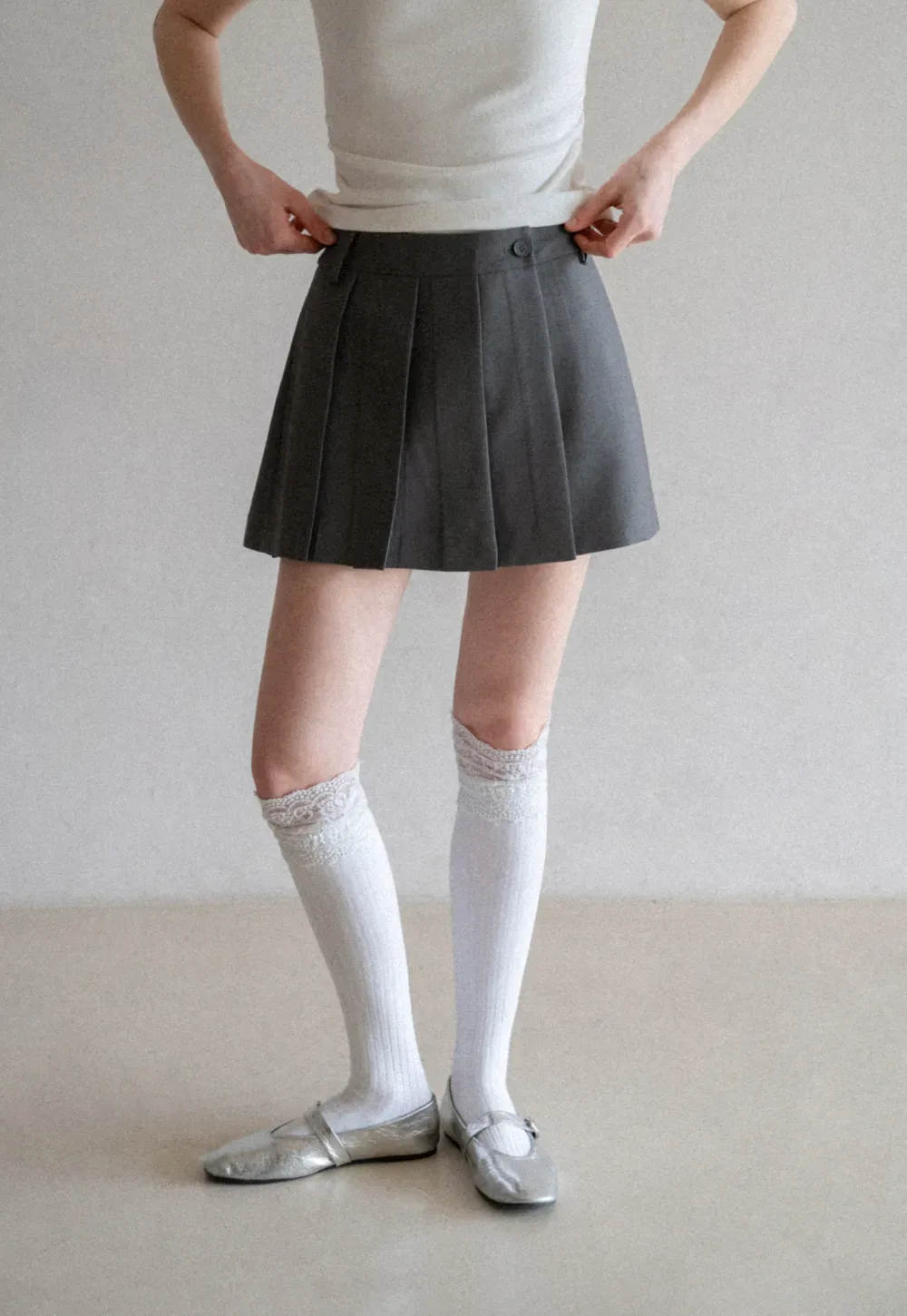 Pleated skirt with front button closure