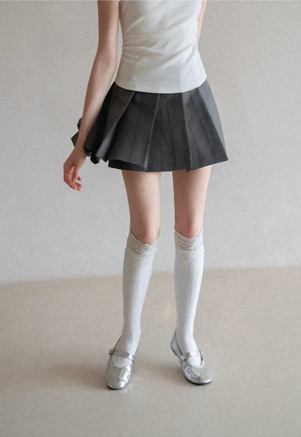 Pleated skirt with front button closure