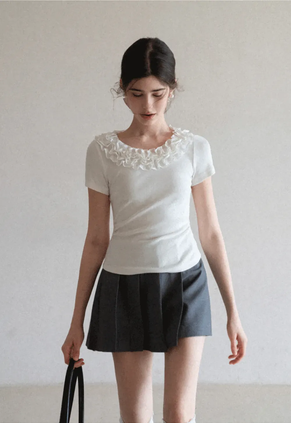 Pleated skirt with front button closure