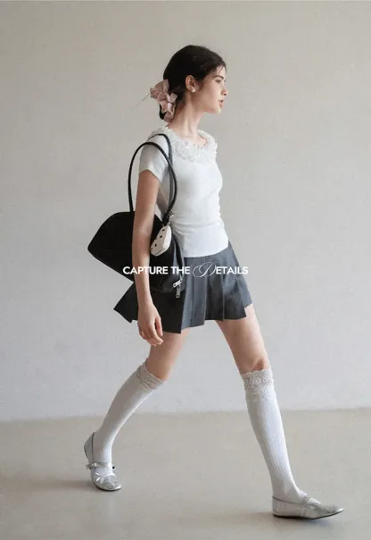 Pleated skirt with front button closure