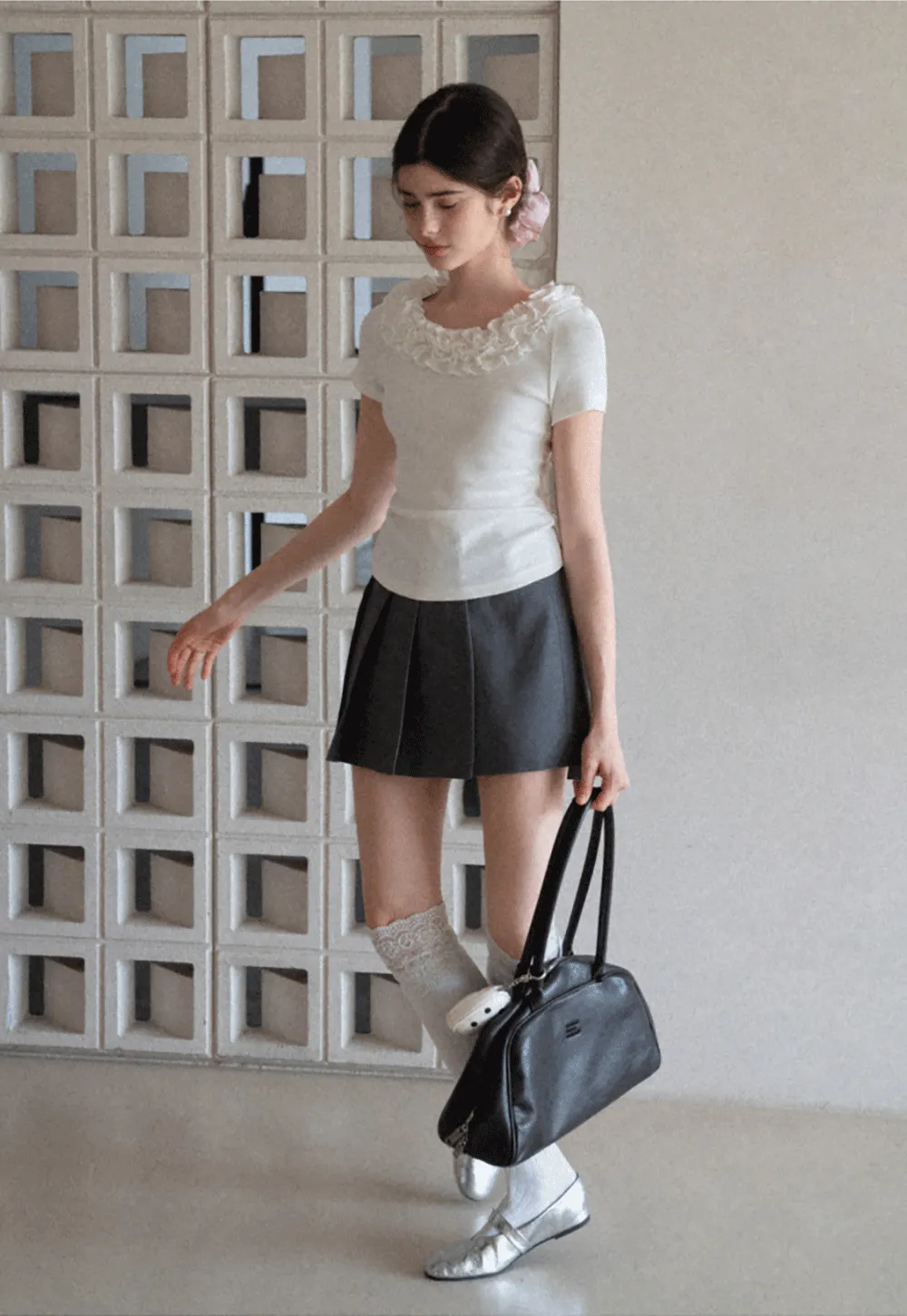 Pleated skirt with front button closure