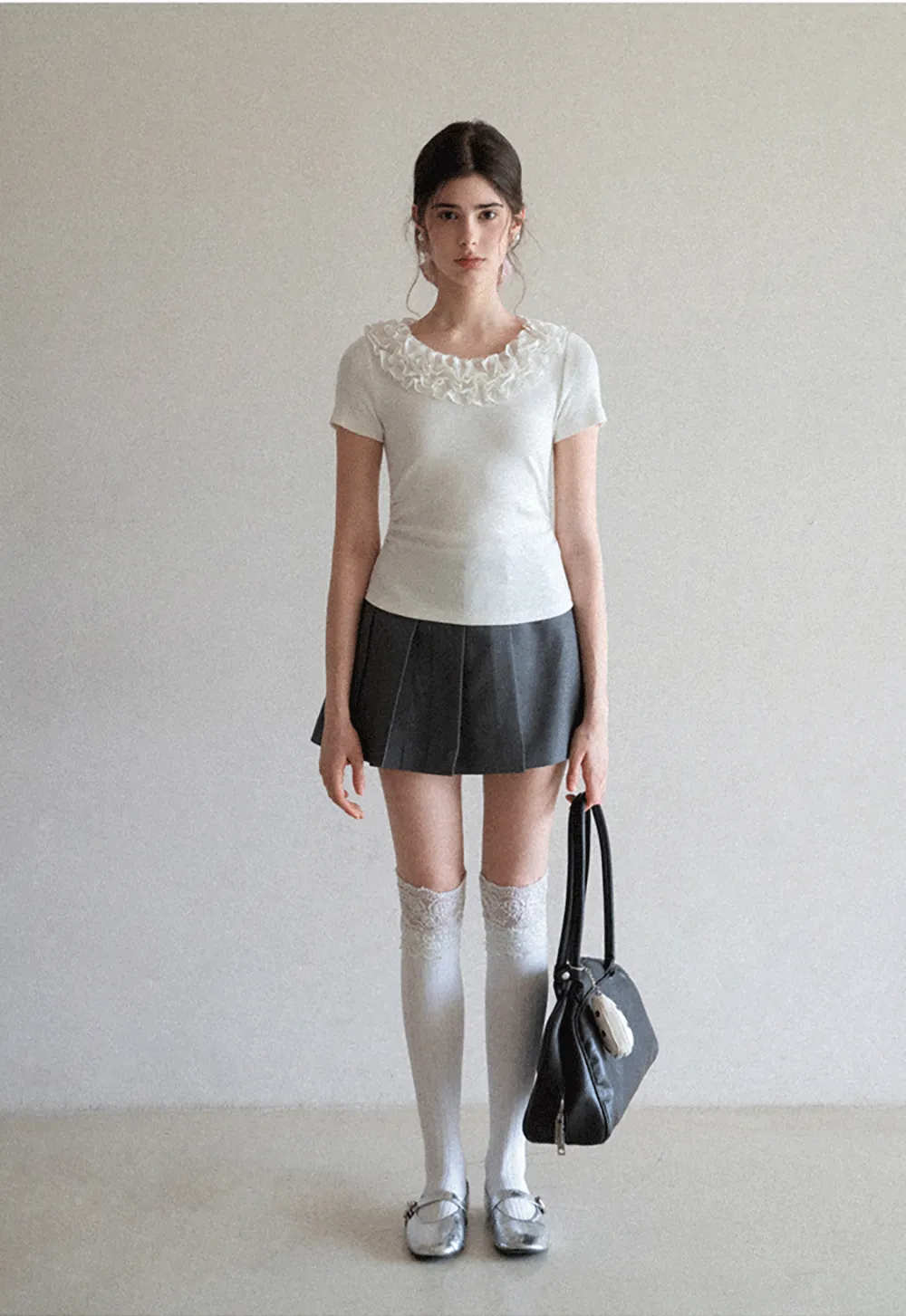 Pleated skirt with front button closure