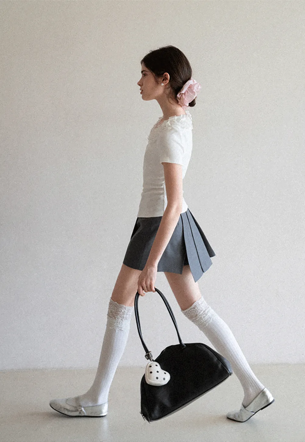 Pleated skirt with front button closure