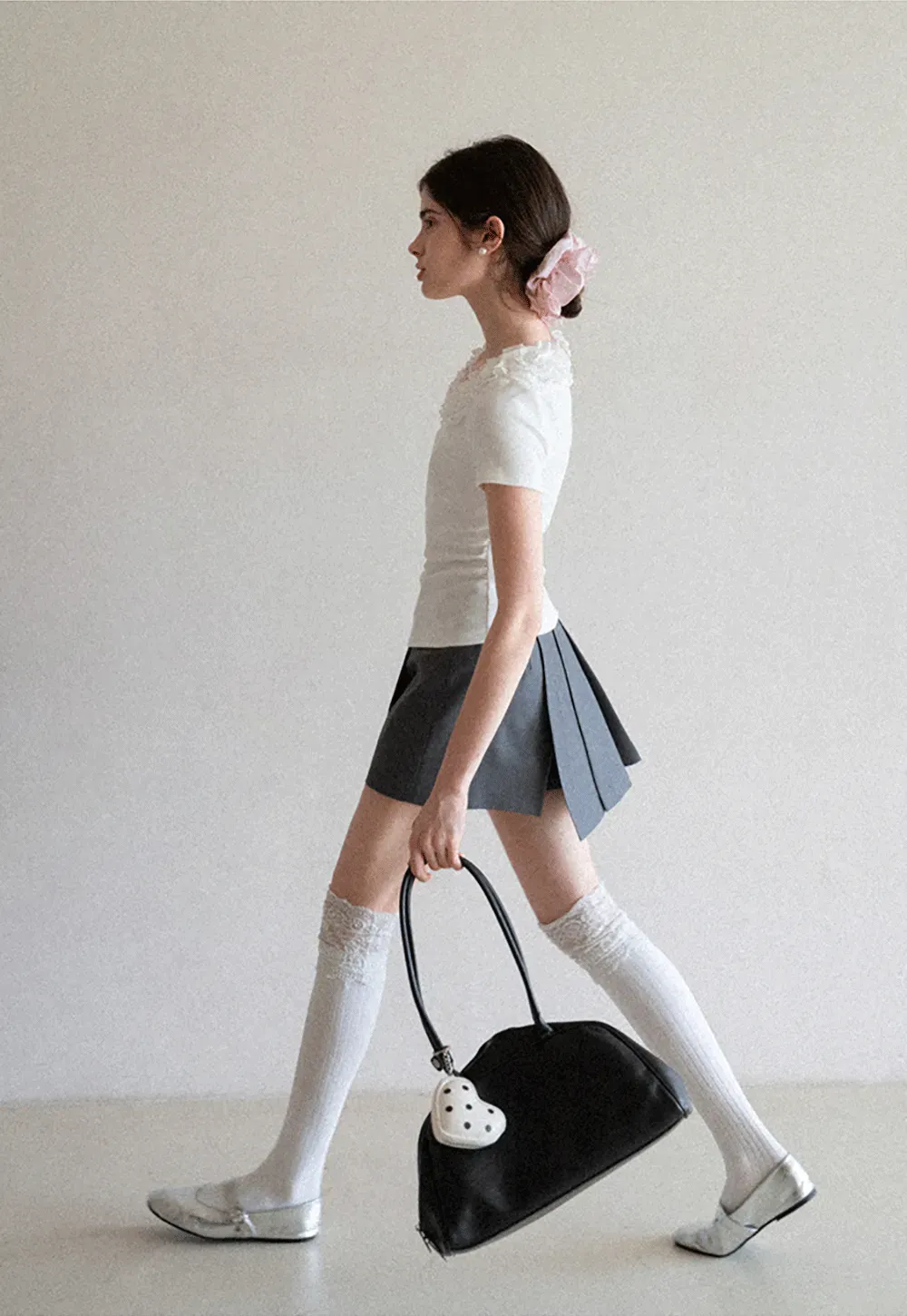 Pleated skirt with front button closure