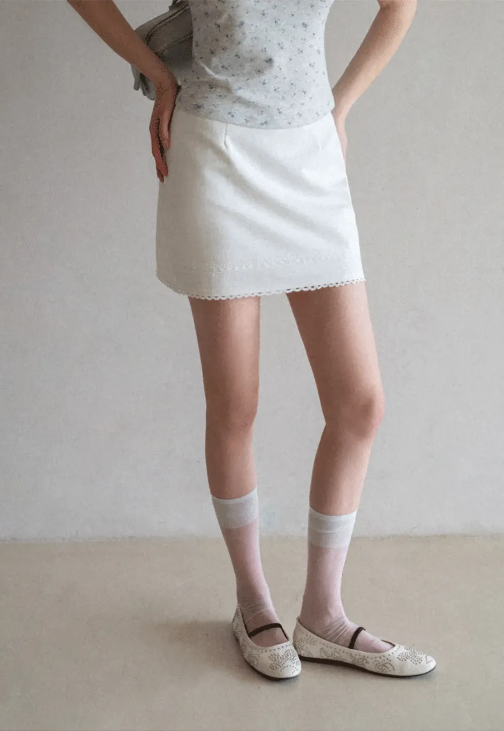 Mini skirt with lace trim at waist and hem