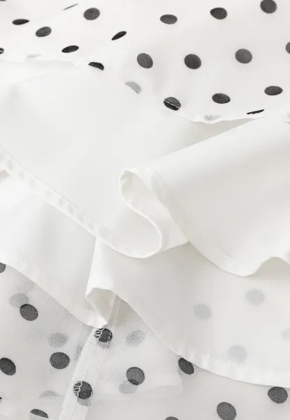 Polka dot pleated asymmetrical skirt