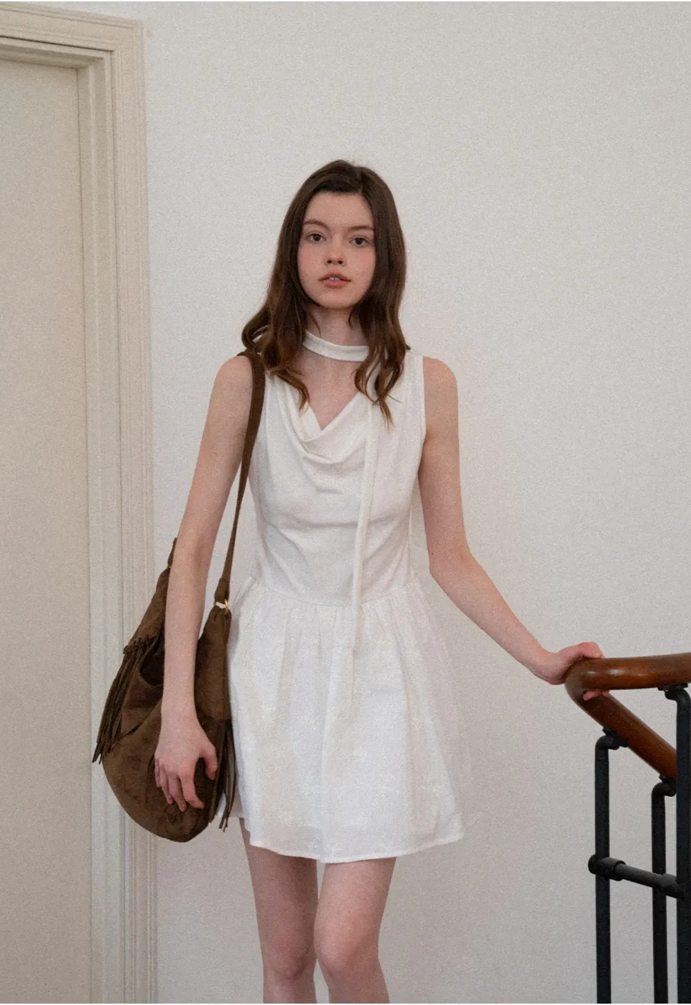 Sleeveless dress with halter neck and flared skirt