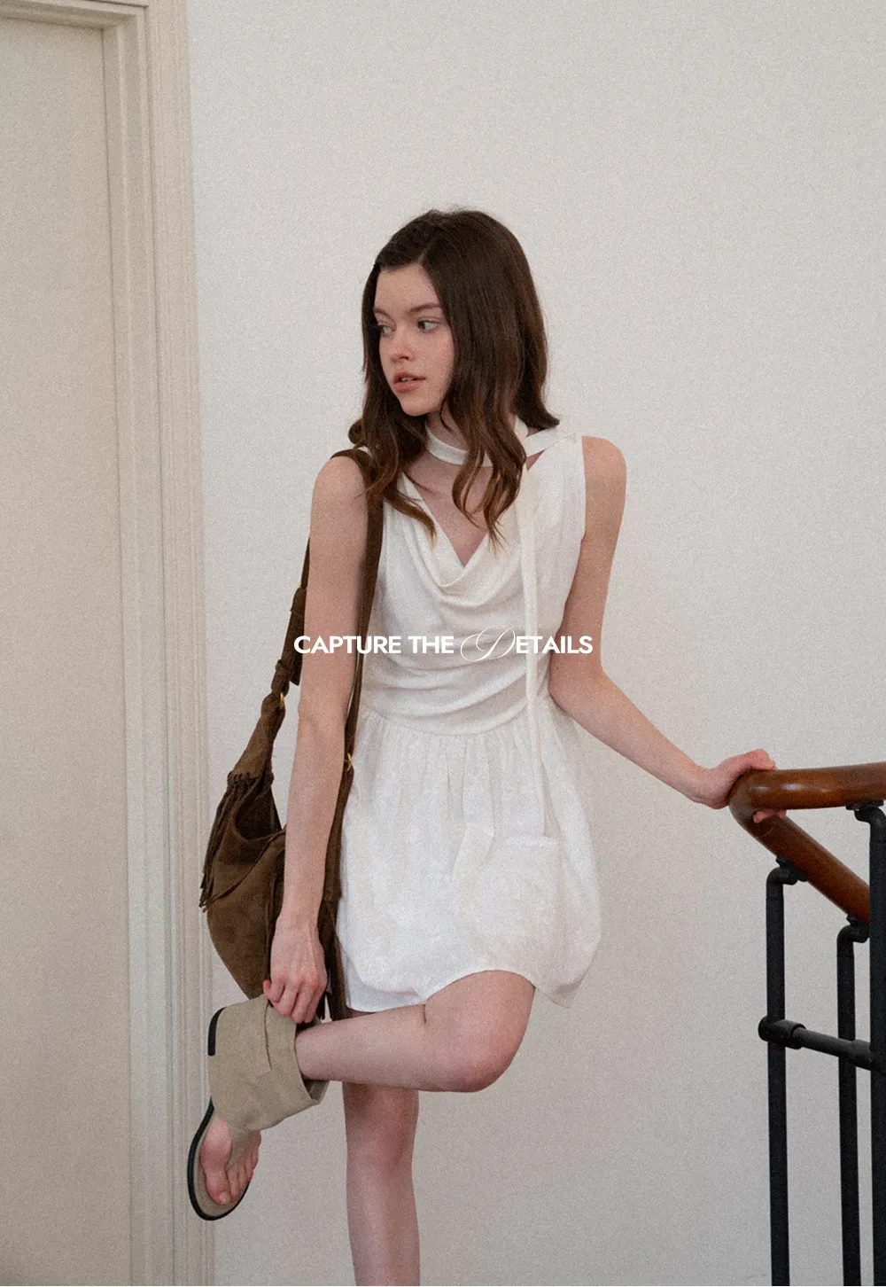 Sleeveless dress with halter neck and flared skirt