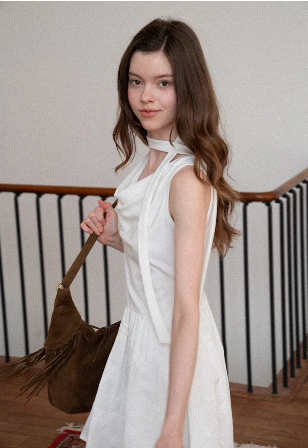 Sleeveless dress with halter neck and flared skirt