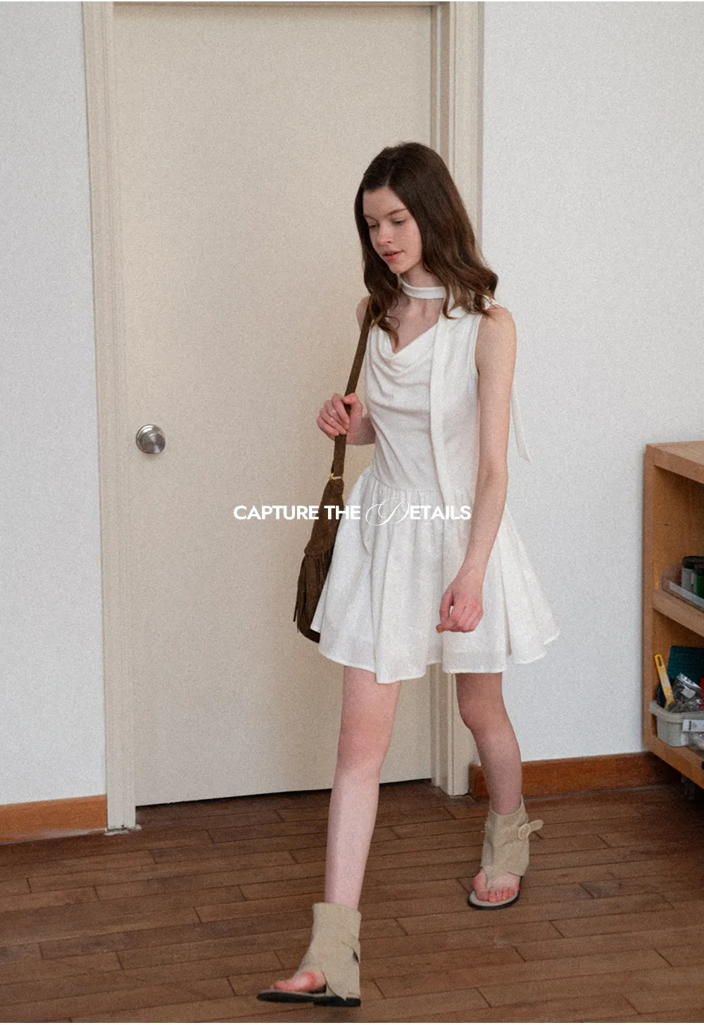 Sleeveless dress with halter neck and flared skirt