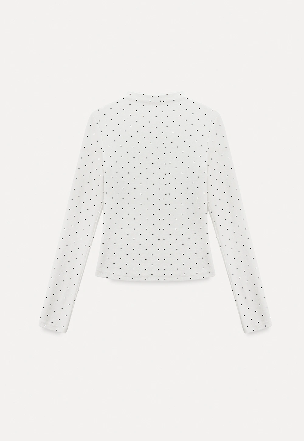 Elegant sleeveless dress with collar layered over polka dot top