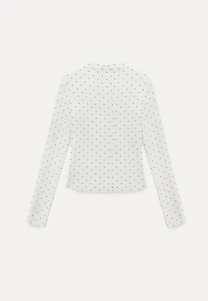 Elegant sleeveless dress with collar layered over polka dot top