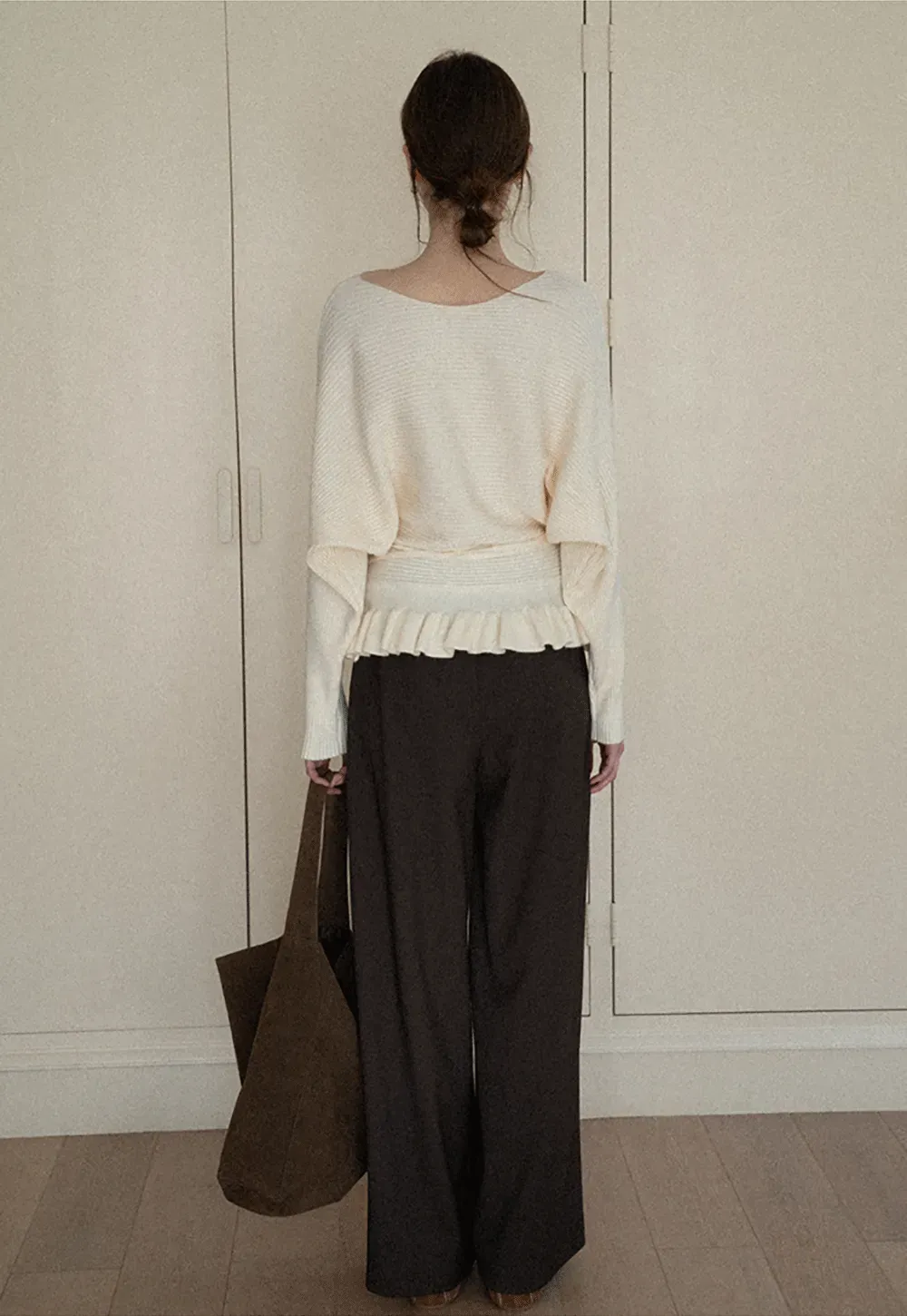 Ribbed knit sweater with tie back and flared hem design