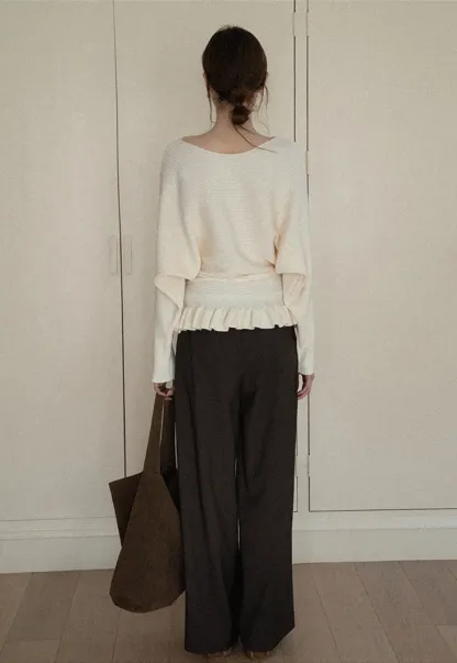 Ribbed knit sweater with tie back and flared hem design