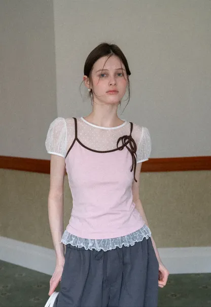 Sheer polka dot top with ruffled hem and puff sleeves