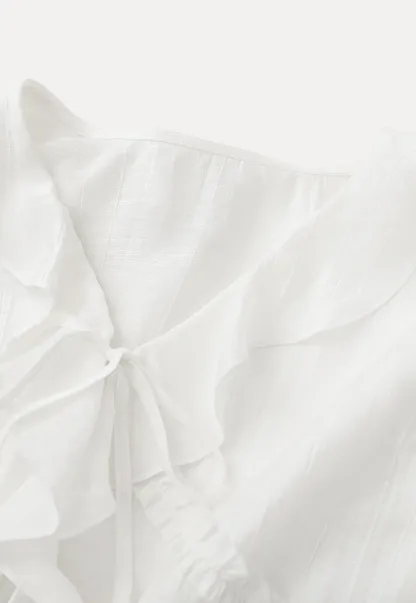 Elegant Blouse with Ruffle Detail and Tie Front Design